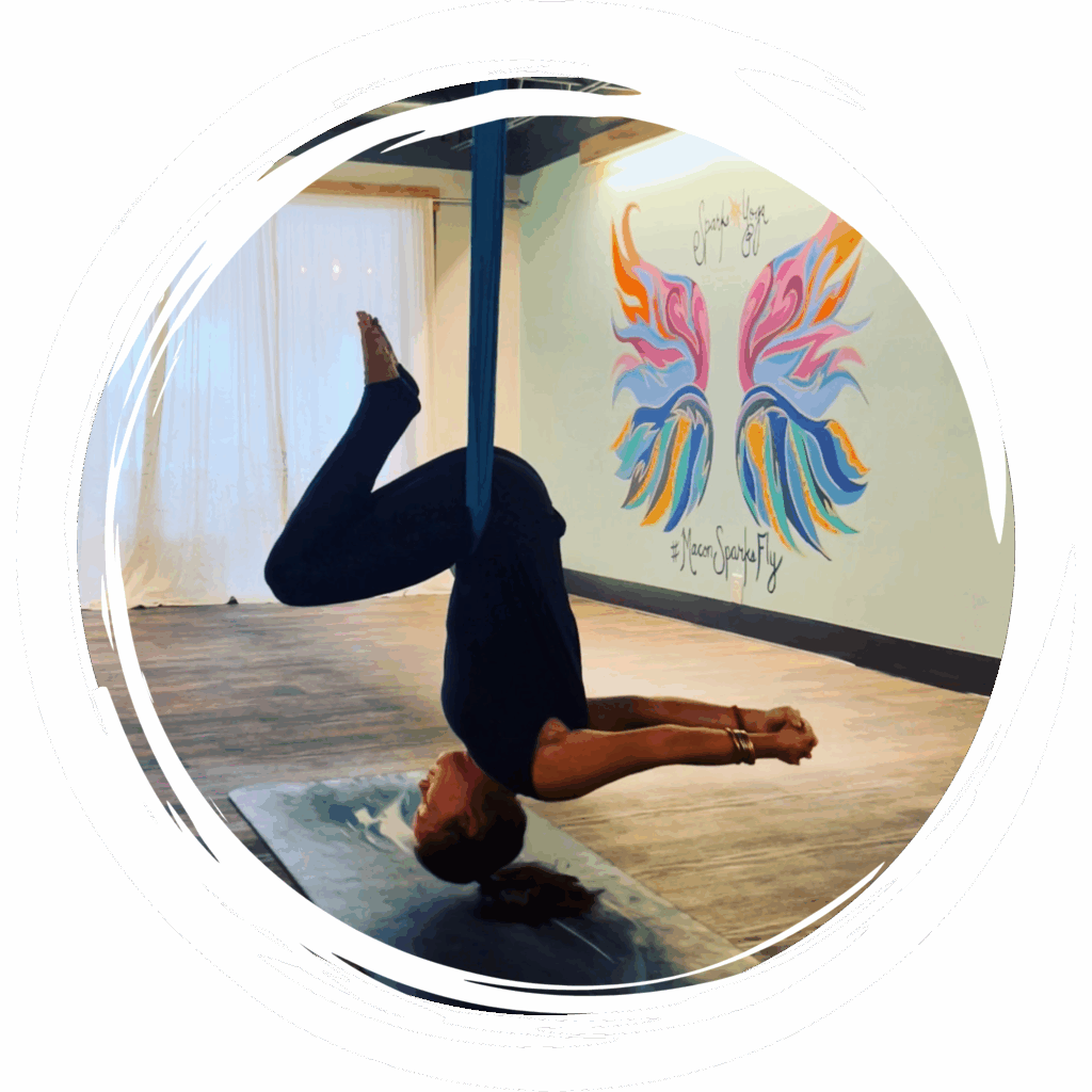 Aerial yoga student practicing in a silk hammock at Sparks Yoga in downtown Macon, GA